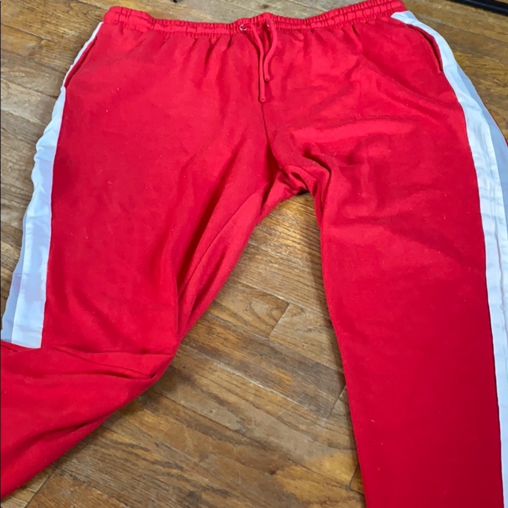 Red sweatpants with gray and white stripes
